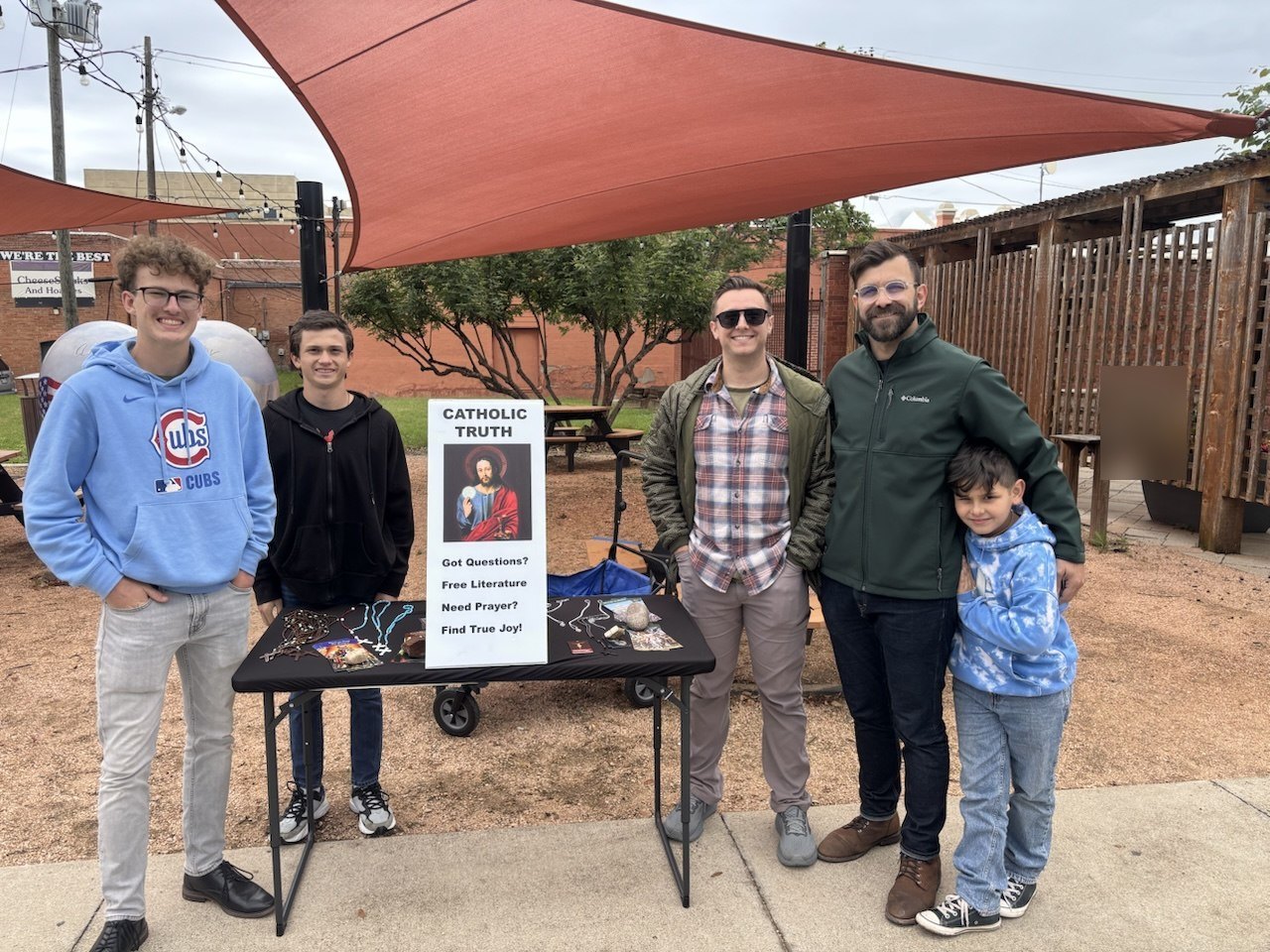 Sons of Joseph members at a Catholic street evangelization table in downtown Waxahachie, Texas
